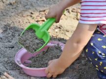 Child digging in sand with shovel