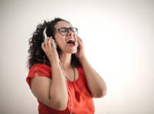 Woman singing with headphones on
