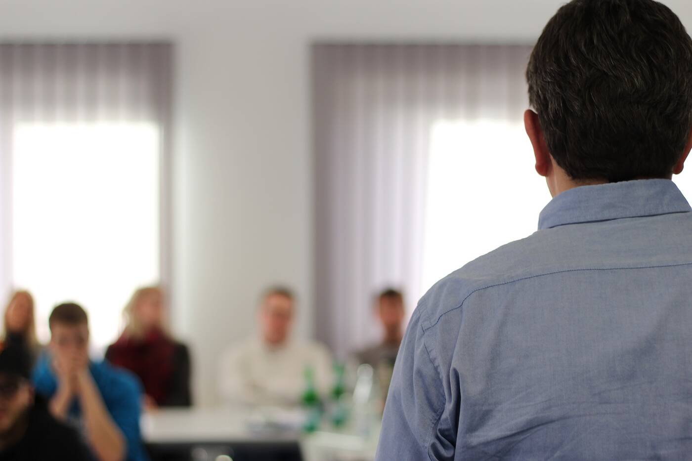 Man lecturing group of people