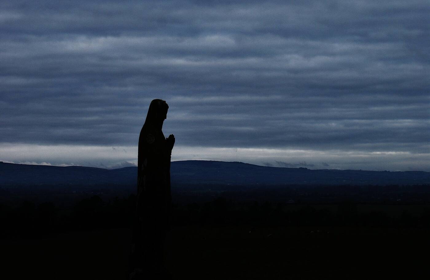 Holy woman walking through blue mist